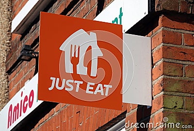 "Just Eat" sign on the wall of Amico Restaurant on the High Street, Billericay, Essex, UK Editorial Stock Photo