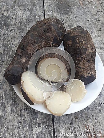 Close up of boiled kimpul food on a small plate.Wooden background. Stock Photo