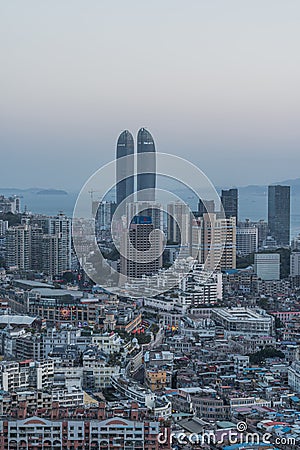 Xiamen city skyline with modern buildings, twin towers, old town and sea at dusk Editorial Stock Photo