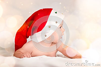 Xmas card with cute baby girl with santa hat on beige airy briht background with copy space Stock Photo
