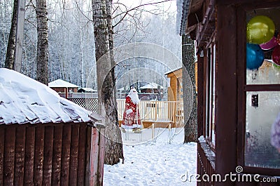 Xmas, cold, December. Santa Claus going with a bag of gifts in the winter on snow-covered field Stock Photo