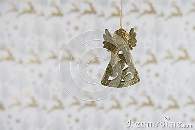 Christmas photography image christmas decoration hanging up of gold glitter angel with reindeer wrapping paper background Stock Photo