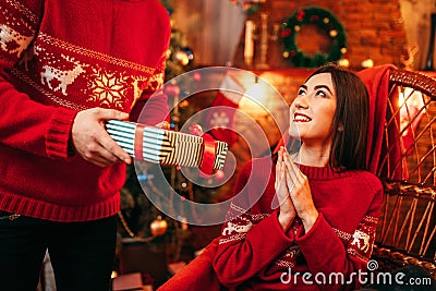 Xmas, male person makes gift to beautiful woman Stock Photo