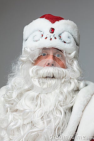 Xmas and new year studio portrait of gray-haired beared surprised male on gray studio background Stock Photo