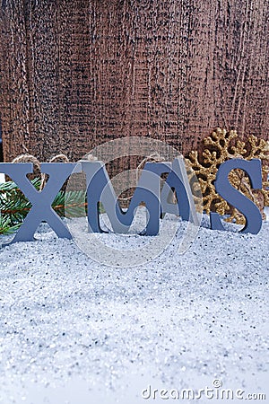 Xmas wooden letters and snowflake on shiny mirrored background, Stock Photo