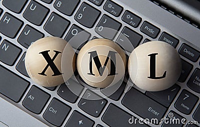 XML - acronym on wooden balls on laptop keyboard background Stock Photo