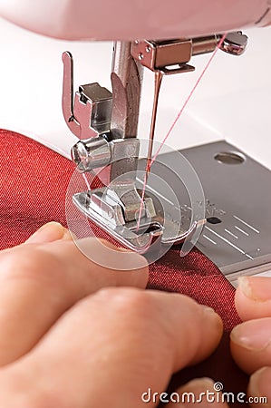 The y woman sews on sewing machine Stock Photo