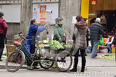 YAAN China-An old woman selling vegetables Editorial Stock Photo