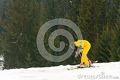 Yablunytsya, Ukraine February 2, 2019: woman in a yellow suit goes skiing, tourists of Ukraine in the village of Yablunytsya Editorial Stock Photo