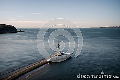 A yacht anchored in a quiet coastal bay Stock Photo