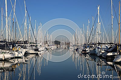 Yacht marina on a calm day with blue sky and reflective water Editorial Stock Photo