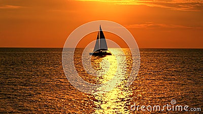 Yacht at orange sunset on the sea Stock Photo