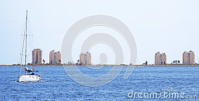 Yacht sailing through the mediterranean sea against La Manga coast, during season of Summer. Yachting as a seasonal activity to Stock Photo