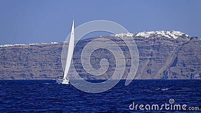 Yacht sailing off Santorini island Stock Photo