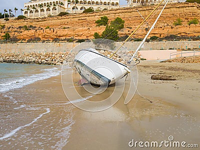 The yacht is shipwrecked and thrown ashore Stock Photo