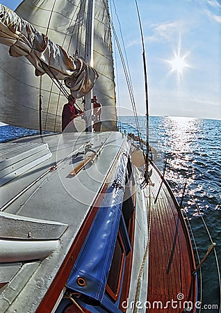 Yacht sport on the Black sea. A yacht is sailing toward beautiful sea sunset. Vertical scenic summer seascape Editorial Stock Photo