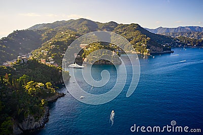 Yachts and boats are sailing in the Ligurian Sea on the mountain background, Portofino, Italy. Rocks and hills seaside with the Stock Photo