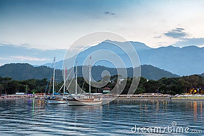 Yachts near the shore of the resort city in the evening Stock Photo