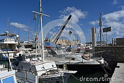 Yachts, sailing boats and old wooden boats with white hulls in Greek port of Heraklion. Stock Photo