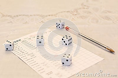 Yahtzee Score Card, Pen and Five Dice Stock Photo