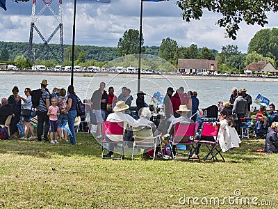 Sailboats fans enjoy big outdoor entertainment event. Open air festival Picnic. Big group of people on grass waiting for armada Editorial Stock Photo