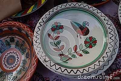 Yakushyntsi, Ukraine, traditional Ukrainian clay plate on sale, Podillia style flower, bird and ornament painting Editorial Stock Photo