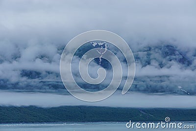 Yakutat Bay, Alaska, USA: Clouds descending on a mountainside Stock Photo