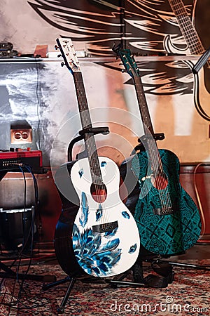 Yamaha acoustic guitar on stand, stage of Royal Pub, custom made instrument ready for O.Torvald rock group Editorial Stock Photo