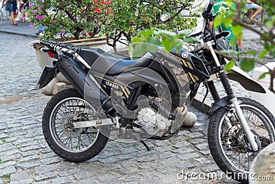 A Yamaha Crosser xtz 150 motorcycle stops on a street in Pelourinho, the historic center of the city of Salvador, Bahia Editorial Stock Photo