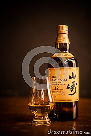 Yamazaki single malt Japanese whisky bottle and a Glencairn whisky glass Editorial Stock Photo