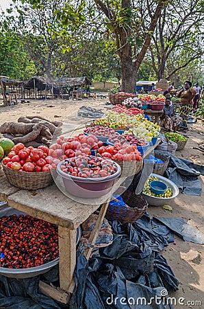 Yamoussoukro, Ivory Coast - January 31,2014: Tomatoes and other vegetables for sale at road side market Editorial Stock Photo