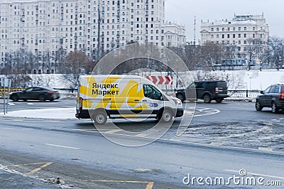 Yandex Market van is driving on city road in winter. White cargo van branded with the Yandex Market logo. Delivery of orders from Editorial Stock Photo
