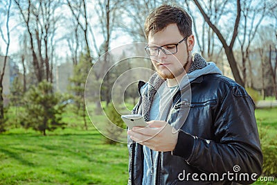 Yang man with smartphone in the park Stock Photo