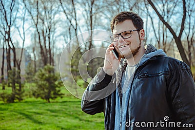 Yang man with smartphone in the park Stock Photo