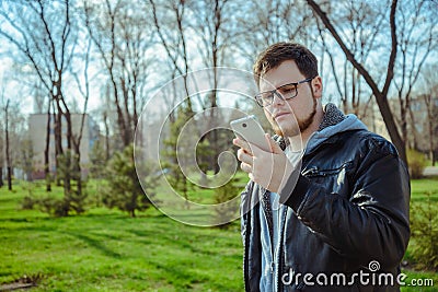 Yang man with smartphone in the park Stock Photo