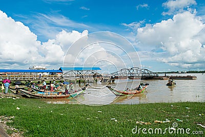 A boat arriving at Botahtaung jetty, carrying Burmese passengers on the Yangon River. Myanmar, Asia Editorial Stock Photo