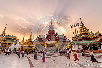 Yangon, Myanmar - Feb 13, 2018: Myanmar peoples and tourists walking around The Shwedagon Pagoda, the most sacred pagoda of Myanma Editorial Stock Photo