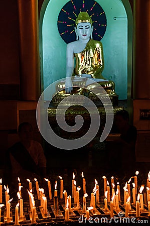 Candles and Buddha in the Shwedagon Pagoda in Yangon Editorial Stock Photo
