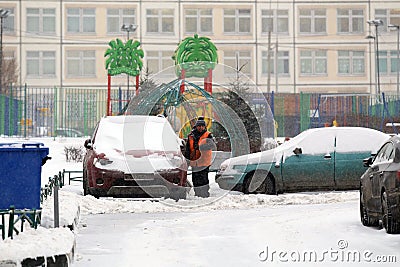 Yard worker is cleaning street from the snow Editorial Stock Photo