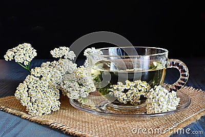 Yarrow medicinal tea in glass cup on dark Stock Photo