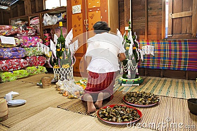 Thai people put food offerings of tradition of almsgiving with sticky rice and food to Buddhist alms bowl at Retro house on Editorial Stock Photo