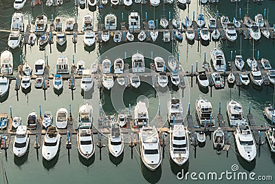 Yatch harbor marina pier and boat dock yatchs and vessels awaiting the open sea. Aerial drone view looking straight down above Stock Photo