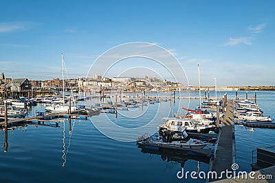 Yatchs moored in Ramsgate Royal Harbour with a view of the town in the background Editorial Stock Photo