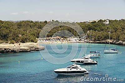 Yatchs in urquoise water in Cala Mondrago view from the sea, Mondrago Natural Park, Majorca Stock Photo