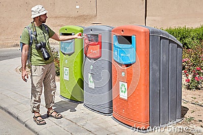 Tourist used coloured recycling wheelie bins for sorting waste, Editorial Stock Photo