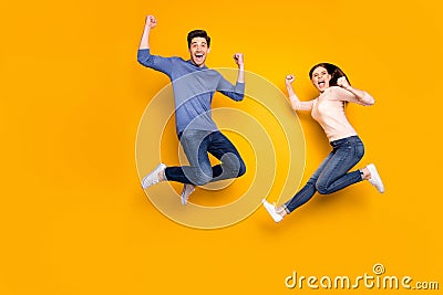 Yeah we winners. Portrait of delighted two married people celebrate lottery victory jump raise fists scream wear casual Stock Photo