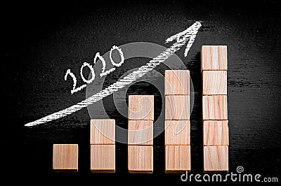 Year 2020 on ascending arrow above bar graph Stock Photo