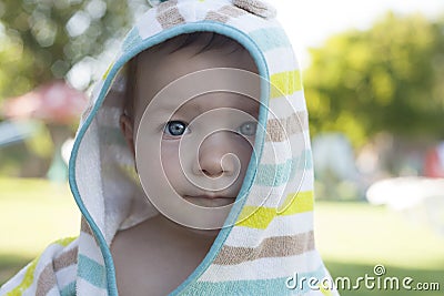 1 year baby boy with hooded poncho towel after swimming Stock Photo