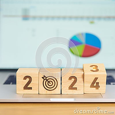 2024 Year block with dartboard icon against computer laptop background. Goal, Target, Resolution, strategy, plan, Action, mission Stock Photo