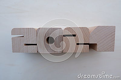 Year 2021 composed with wooden numbers over a wooden board Stock Photo